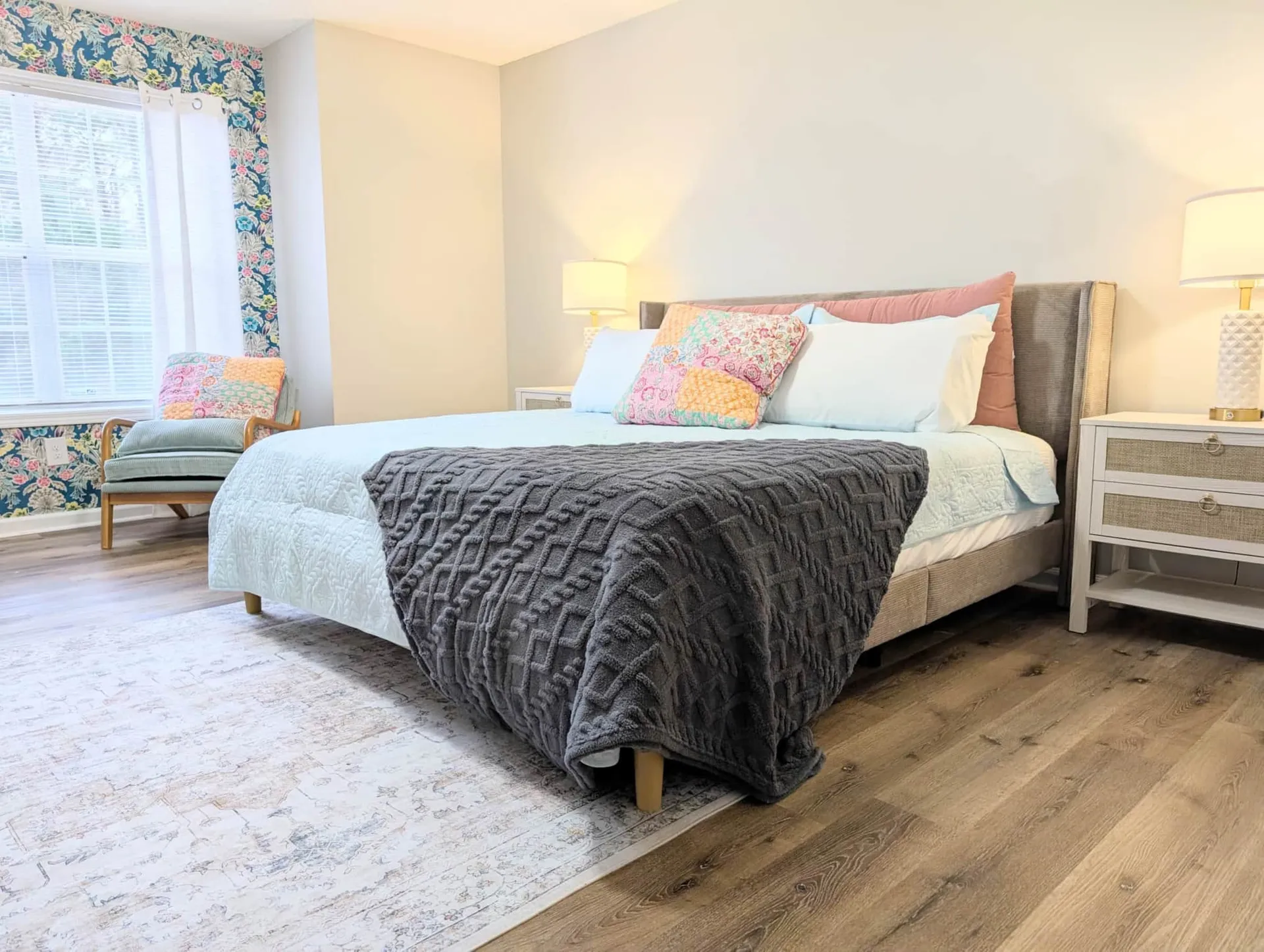 Bright furnished bedroom with soft floral details