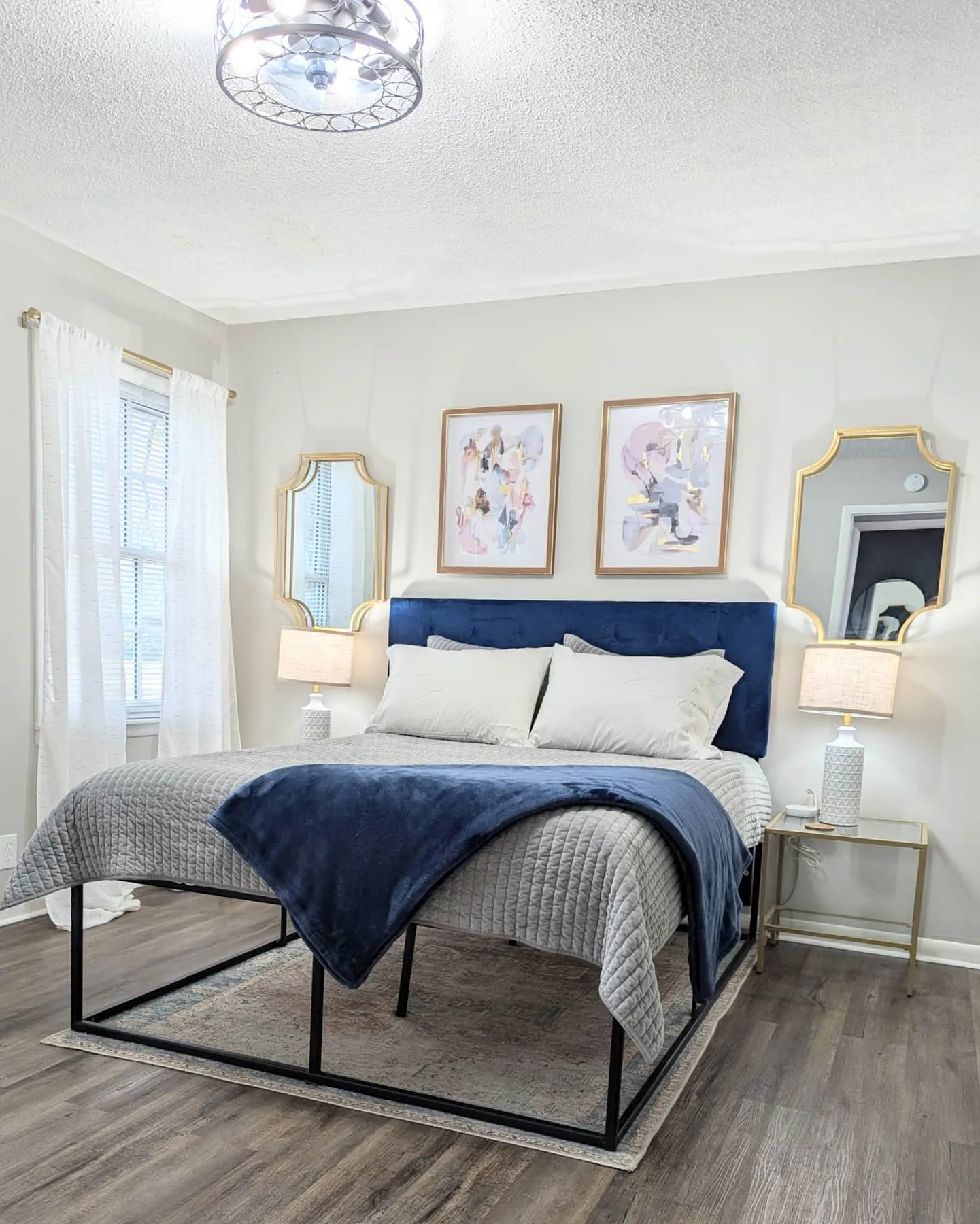 Bedroom in a Blue Brick home, dressed in crisp linens and navy accents
